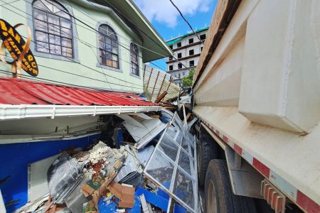 The photo shows the out-of-control truck embedded in the Greenhouse apartment complex 