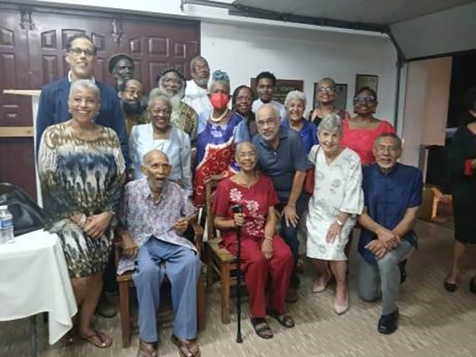 Sir Roy Augier sitting at left is surrounded by some of his former UWI students and colleagues, as well as current staff members after the mass to celebrate his 100th birthday on Tuesday, December 17 at the St Thomas Aquinas Church in Mona, St Andrew