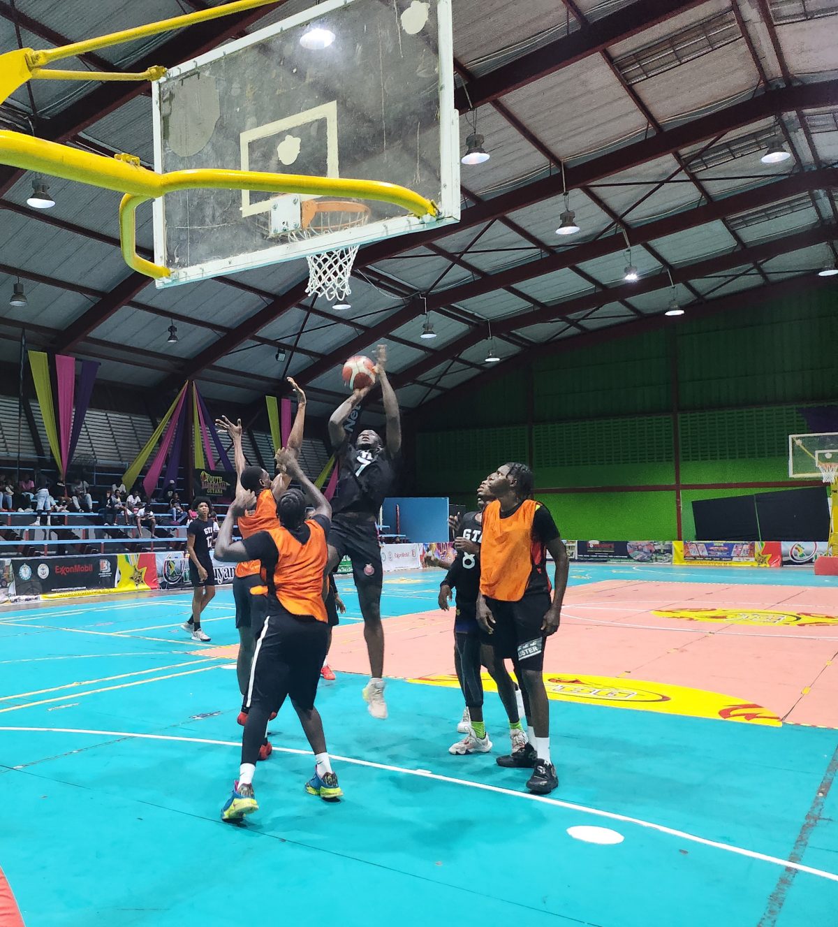 A scene from the GTI (black) and NATI encounter in the Tertiary Basketball Championship
