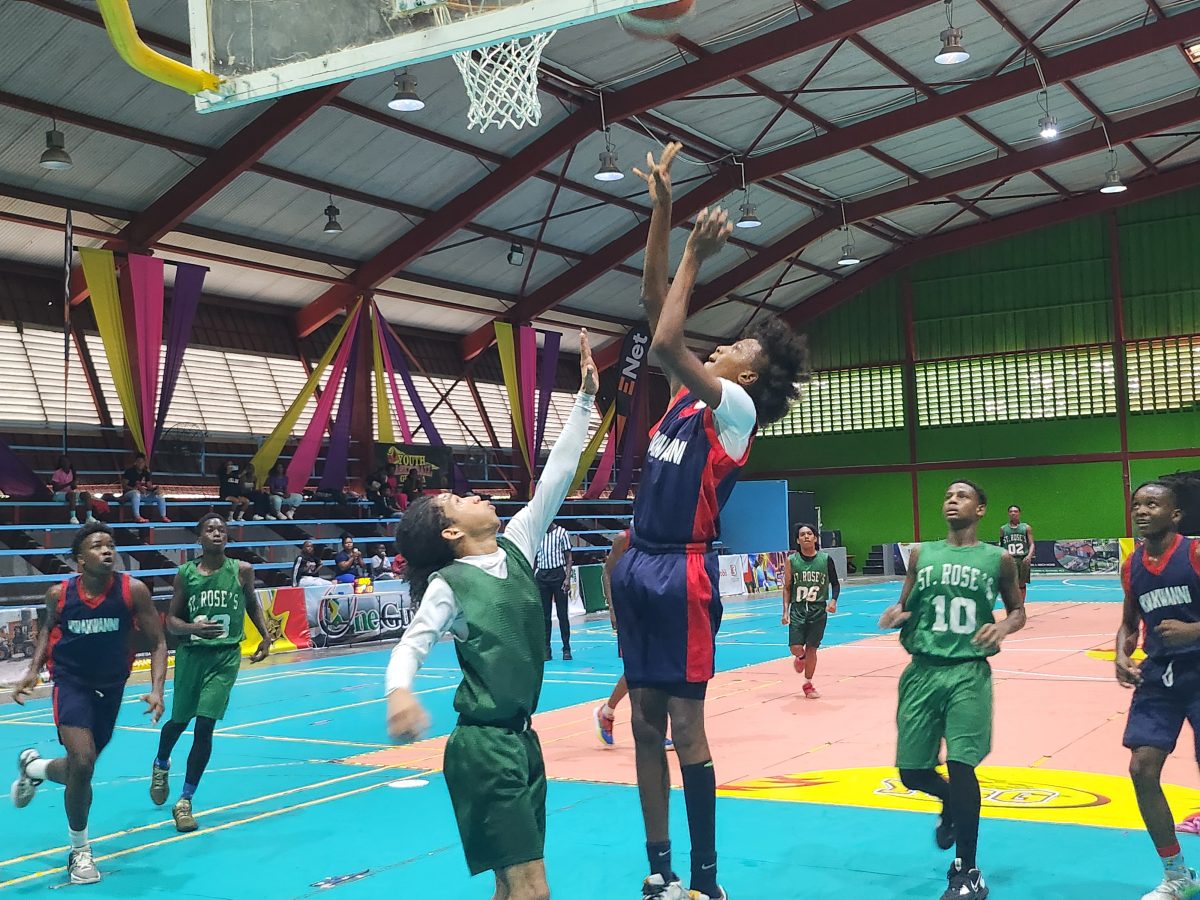 Action between Kwakwani (blue) and St. Rose’s High in the Titan Bowl Secondary School Basketball Championship.