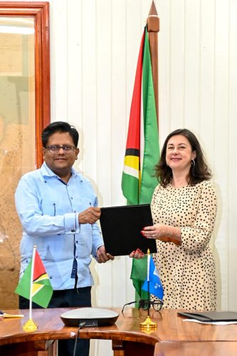 Ashni Singh (left) and Diletta Doretti with the new agreement. (Ministry of Finance photo)