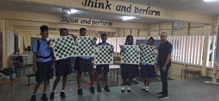 Five tournament-size chess sets were recently donated to the East Ruimveldt Secondary School through the Guyana Chess Federation by “the Friends of Guyana Chess” of the USA. Presenting the sets on behalf of the GCF was Shiv Nandalall. Headmistress of the school Katheryn Fraser noted that the introduction of the game would greatly benefit students.