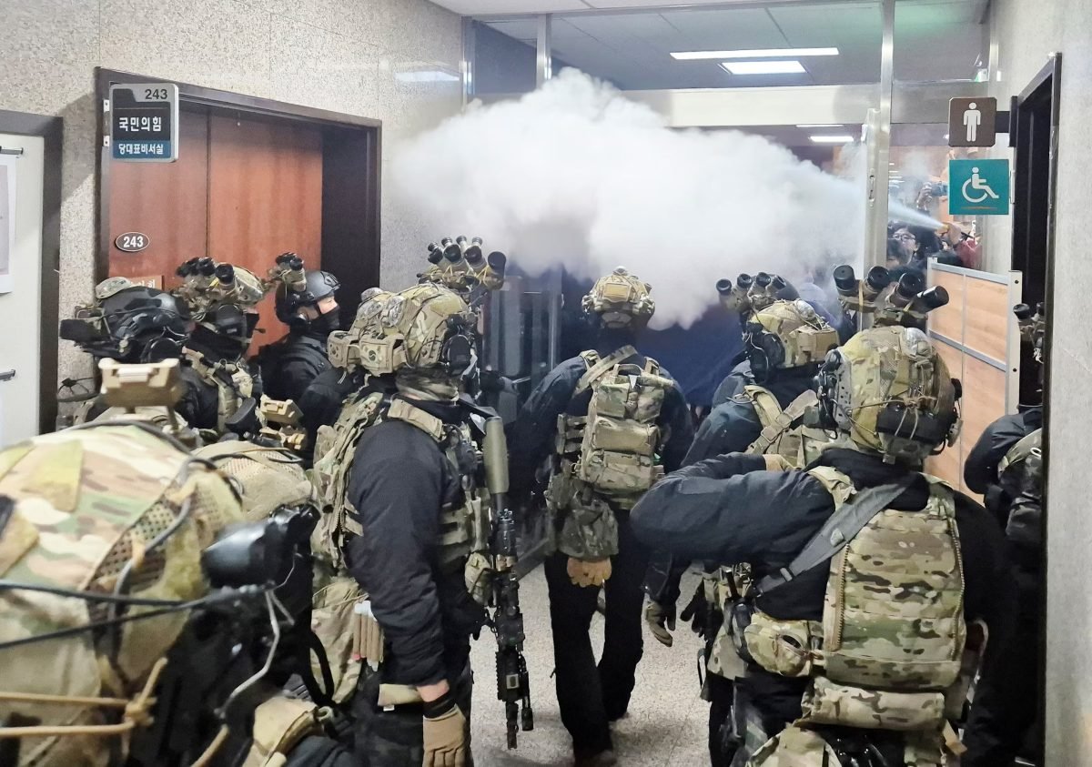 Soldiers advance to the main building of the National Assembly after South Korean President Yoon Suk Yeol declared martial law. via Yonhap via REUTERS 