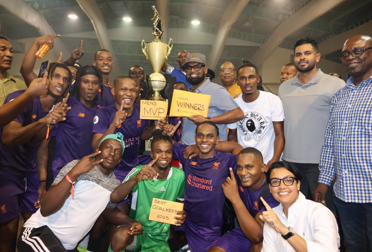 The victorious Sparta Boss unit celebrates as they display their spoils in the presence of President Irfaan Ali (centre) after triumphing in the Kashif and Shanghai National Futsal Championship. Also in the photo are Minister of Culture, Youth, & Sport Charles Ramson Jr. (2nd from right), Minister of within the Ministry of Housing & Water Susan Rodrigues (crouched 1st from right), and Minister of Public Works Juan Edghill (5th from right).
