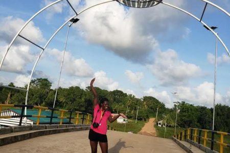 A visitor posing for a picture on the Kumaka San Jose Bridge 