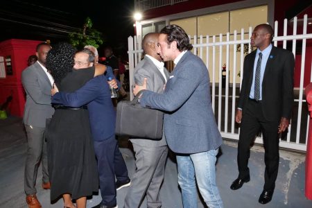 Education Minister Dr Nyan Gadsby-Dolly and Energy Minister Stuart Young hug each other, at left, while Minister of Youth Development and National Service Foster Cummings and Minister of Rural Development and Local Government Faris Al-Rawi also embrace each other after the PNM’s Central Executive meeting at Balisier House last night. In the background, partly hidden, are Ministers Marvin Gonzales and Terrence Deyalsingh.