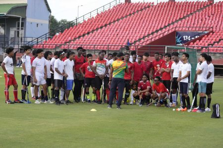 The boys coach addresses them during a recent training session