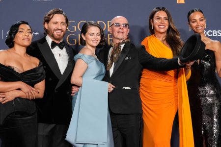 Adriana Paz, from left, Edgar Ramirez, Selena Gomez, Jacques Audiard, Karla Sofia Gascon and Zoe Saldana pose in the press room with the award for best motion picture - musical or comedy for "Emilia Perez" during the 82nd Golden Globes, Jan. 5, 2025, at the Beverly Hilton in Beverly Hills, Calif. (AP Photo/Chris Pizzello)