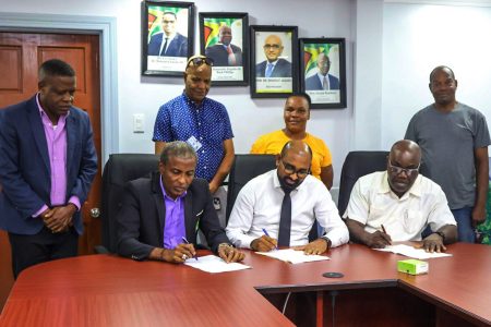 Seated from left are Mayor of Georgetown Alfred Mentore,  Chief Labour Officer,  Dhaneshwar Deonarine and Carvil Duncan, General Secretary of the GLU. (Ministry of Labour photo)