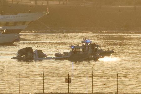 Rescue boats work at the site of the wreckage of the American Eagle flight 5342, after it collided with a Black Hawk helicopter while approaching Reagan Washington National Airport and crashed into the Potomac River, outside Washington, DC, January 30, 2025. REUTERS/ Eduardo Munoz