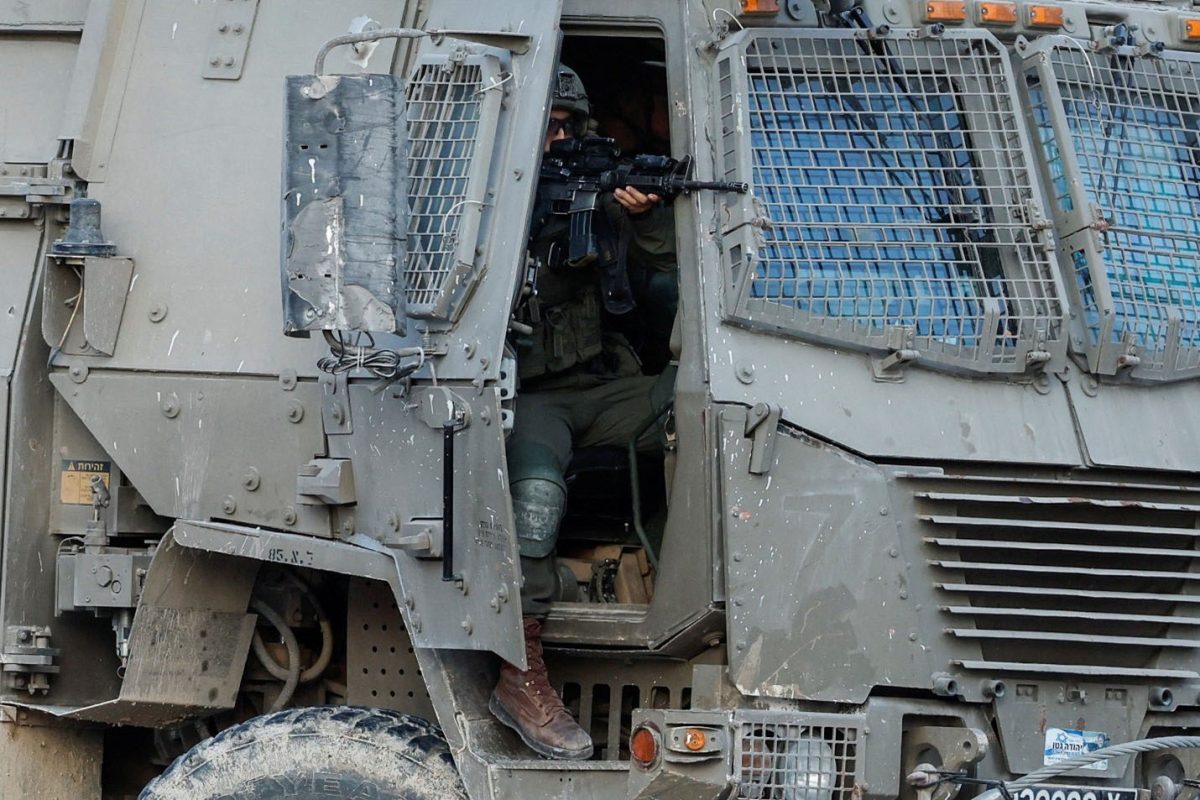 An Israeli soldier holds a weapon in a military vehicle, during an Israeli raid in Tulkarm, in the Israeli-occupied West Bank, October 31, 2024. REUTERS/Raneen Sawafta/File Photo