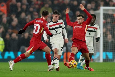 Manchester United's Manuel Ugarte in action with Liverpool's Alexis Mac Allister and Curtis Jones REUTERS/Phil Noble
