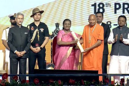 In this Indian High Commission photo, the President of India, Draupadi Murmu  makes the presentation to  Swami Aksharananda. Also in the photo at left is India’s Minister of External Affairs, Dr Subrahmanyam Jaishankar (Indian High Commission photo)