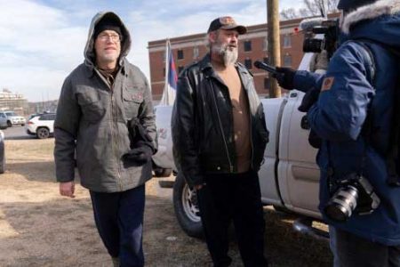 Supporters of President Donald Trump, Kevin Loftus, left and William Sarsfield III, center, who were convicted for participating in the Jan. 6 riot at the U.S. Capitol, talk to reporters after being pardoned and released in the early morning hours from the Philadelphia Federal Detention Center before traveling to Washington. (AP Photo)