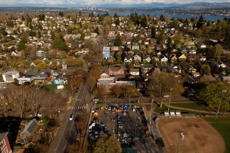 In an aerial photograph taken with a drone, a group of mostly Venezuelan migrants camp on the tennis courts of a community center after losing access to other shelter in Seattle, Washington , U.S. April 3, 2024. REUTERS/David Ryder/File Photo