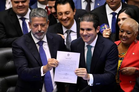 Brazil's Lower House Speaker Arthur Lira (left) and Hugo Motta, elected speaker of the House, pose in Brasilia