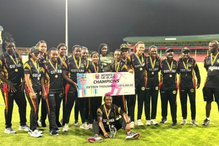History! The victorious Guyana women’s team posed with the spoils after dethroning Jamaica on Sunday night. 