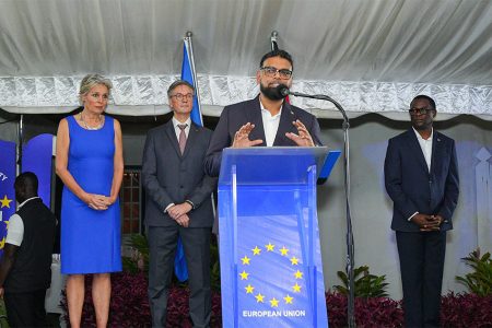 President Irfaan Ali speaking last evening. From left are Jeannette van Bodegraven, wife of the EU Ambassador; EU Ambassador René van Nes and Guyana’s Foreign Minister, Hugh Todd.