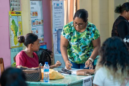 The cash grant being handed out (Ministry of Education photo)