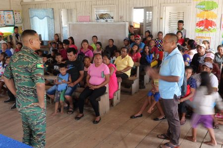 Chief of Defence Staff of the Guyana Defence Force (GDF), Brigadier Omar Khan (left) speaking to residents during an outreach earlier this week to Eteringbang and Arau in Region Seven. The visit came amid rising concerns about Venezuelan aggression. (Office of the President photo)  