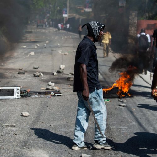 Protesters stand near burning objects in a street in Port-au-Prince, Haiti, on March 27, 2025. © Clarens Siffroy, AFP