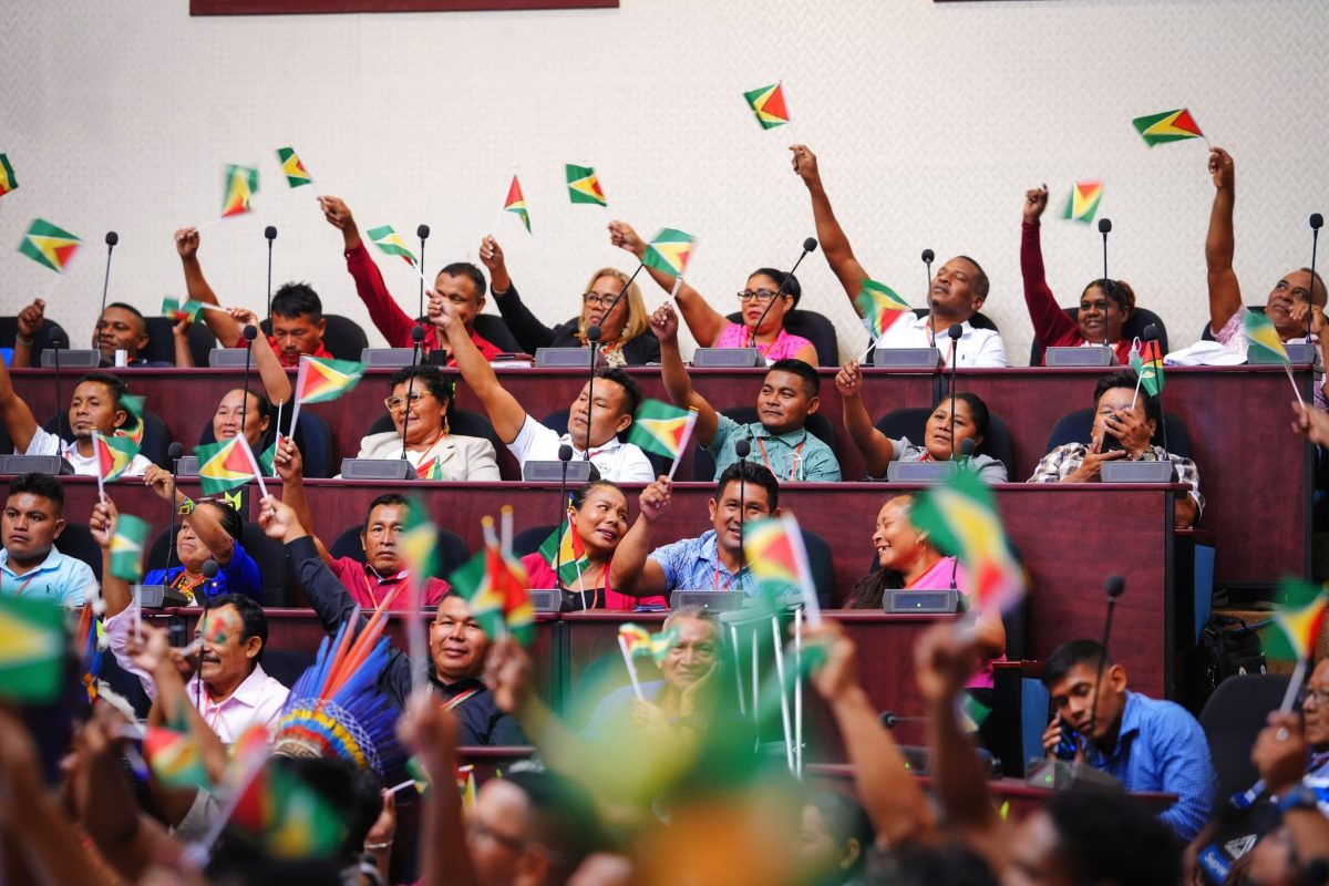 Toshaos waving the Guyana flag on the opening day of the National Toshaos Conference at the Arthur Chung Con-ference Centre yesterday. (Office of the President photo)