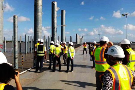 Members of the media and representatives from Polytechnica inspecting work on the 100 percent completed temporary structure of the Demerara Harbour Bridge (Stabroek News’ File photo)
