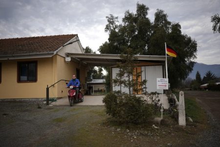 Rudiger Schmidtke leaves his house riding his electric tricycle in Villa Baviera, formerly Colonia Dignidad, on the outskirts of Parral, Chile, July 20. REUTERS/Pablo Sanhueza 