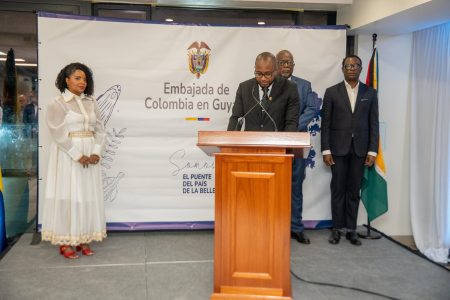 Colombian Ambassador to Guyana, Graybern Livingston Forbes speaking last evening at the recommissioning of his country’s embassy in Guyana. Prime Minister Mark Phillips and Foreign Minister Hugh Todd are standing behind him at right. (Office of the Prime Minister photo)  
