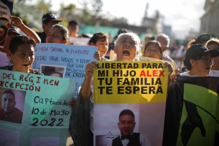 Women hold pictures of their relatives who were detained during the state of emergency, decreed by the government to curb gang violence, during a protest demanding their release, in San Salvador, El Salvador, July 12, 2025. REUTERS/Jose Cabezas/File Photo