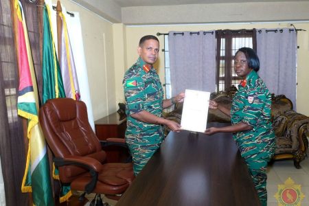 Chief of Defence Staff, Brigadier Omar Khan handing over the instrument of appointment to Colonel Lorraine Foster (GDF photo)