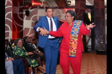 Prime Minister of Jamaica Dr Andrew Holness and Barbados Prime Minister Mia Mottley share a dance during the opening ceremony of the 49th Regular Meeting of The Conference of Heads of Government of CARICOM, held on Sunday at the Montego Bay Convention Centre in St James.