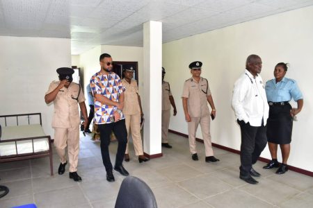 Minister of Home Affairs Robeson Benn (right) during a tour of one of the stations (Ministry of Home Affairs  photo)