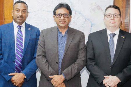 Attorney General Anil Nandlall SC (centre) with Sandy Rao (left) and Timothy Semons
