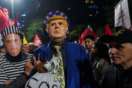 Demonstrators wearing costumes and masks depicting former Brazilian President Jair Bolsonaro and U.S. President Donald Trump take part in a protest against U.S. President Donald Trump's announcement of 50% tariffs on Brazilian products, in Sao Paulo, Brazil July 10, 2025. REUTERS/Alexandre Meneghini/File Photo
