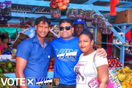 Azruddin Mohamed (centre) at the market
