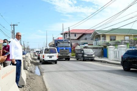 Minister of Public Works Juan Edghill (left) inspects the ongoing roadworks (DPI photo)