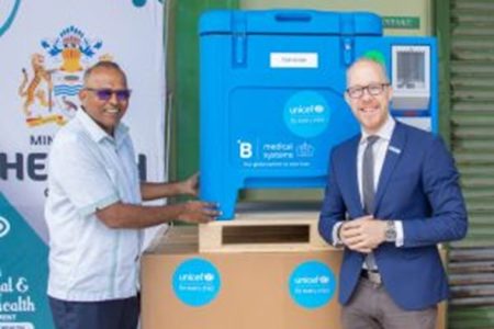 Health Minister Dr Frank Anthony (left) receiving  the refrigerators from Gabriel Vockel, UNICEF Representative (Ministry of Health photo)