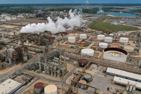 An aerial view shows flue gas and steam rising from a distillation tower at Exxon Mobil’s Beaumont oil refinery, which produces and packages Mobil 1 synthetic motor oil, in Beaumont, Texas, U.S., March 18, 2023. REUTERS/Bing Guan/File Photo 