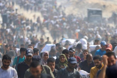 Palestinians carry aid supplies they collected from trucks that entered Gaza through Israel, in Beit Lahia, in the northern Gaza Strip August 10, 2025. REUTERS/Dawoud Abu Alkas