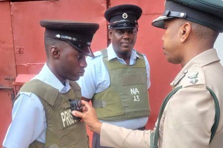 Prisons chief Nicklon Elliott (right) adjusting a camera (GPS photo)