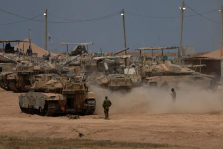 A view shows military vehicles on the Israeli side of the border with Gaza, as seen from Israel, August 12, 2025. REUTERS/Ammar Awad