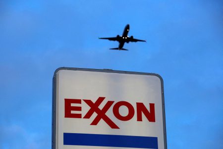 An airplane comes in for a landing above an Exxon sign at a gas station in the Chicago suburb of Norridge, Illinois, U.S., October 27, 2016. REUTERS/Jim Young/File Photo 