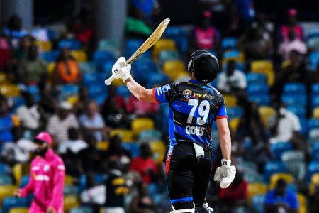  Antigua and Barbuda Falcons batsman Andries Gous raises his bat after getting to a half-century. (CPL T20 via Getty Images)
